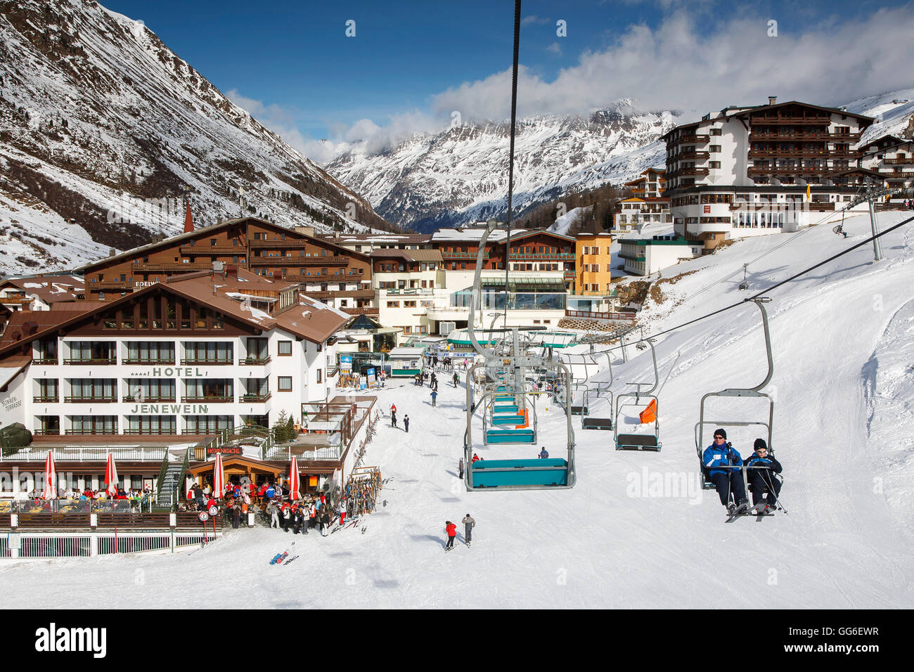 Alpine skiing village of Obergurgl, skiers relaxing while others head off on chairlifts, Otztal Alps, Tyrol, Austria Stock Photo