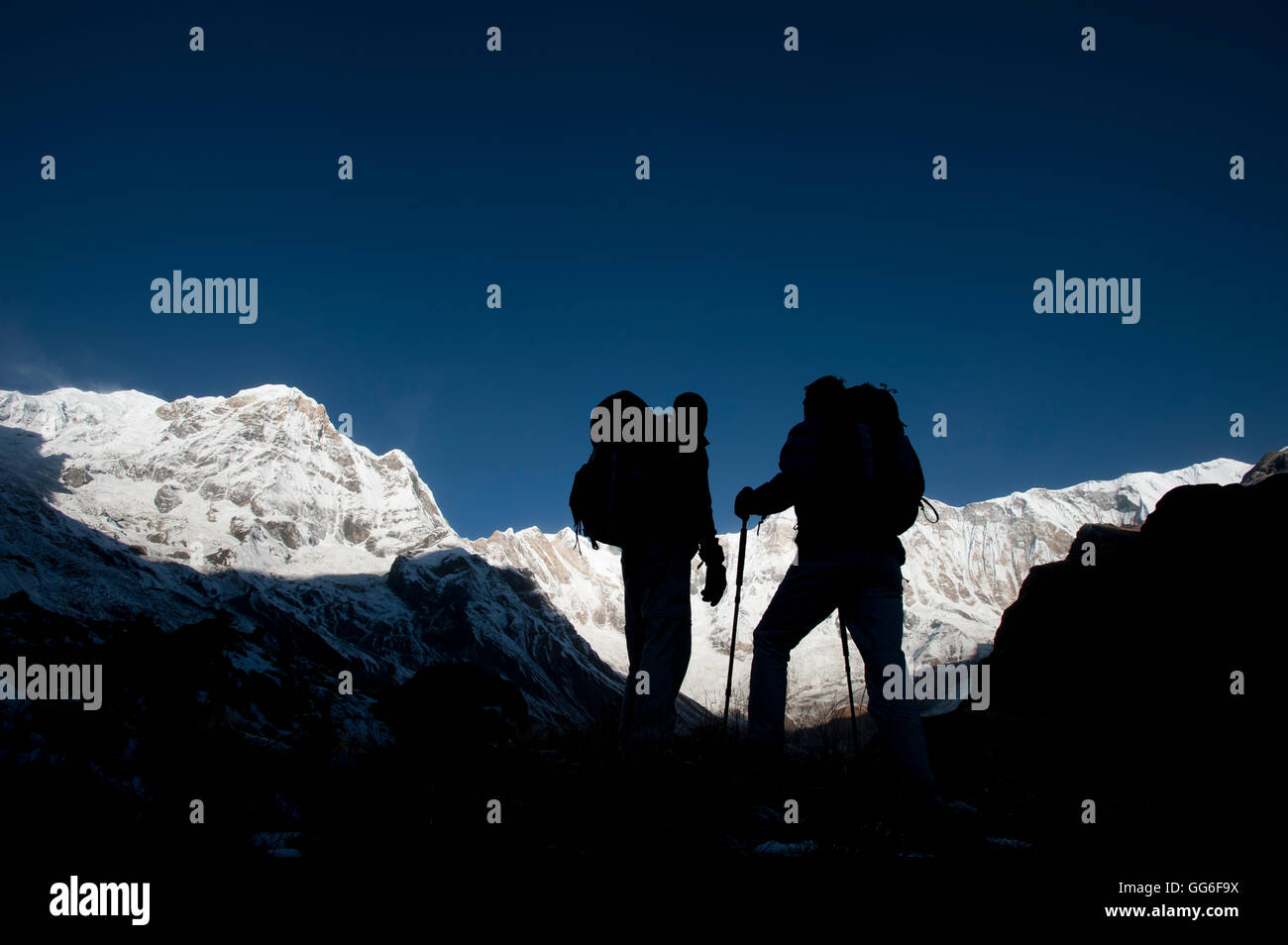 Trekkers on their way down from Annapurna base camp with views of Annapurna 1 in the distance, Himalayas, Nepal, Asia Stock Photo
