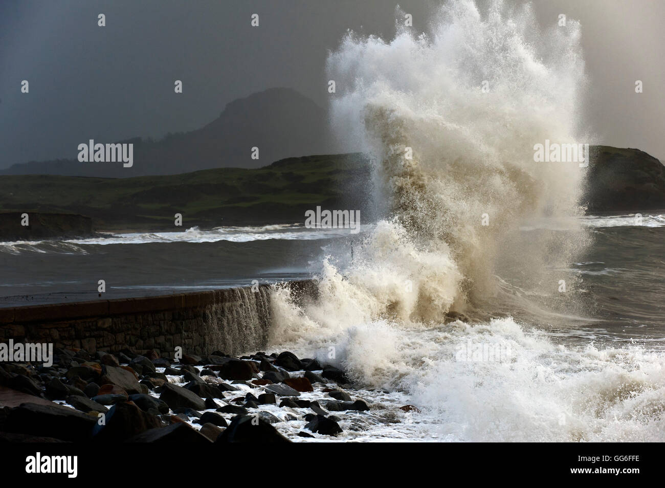 Huge waves crash against a stone jetty at Criccieth, Gwynedd, Wales, United Kingdom, Europe Stock Photo