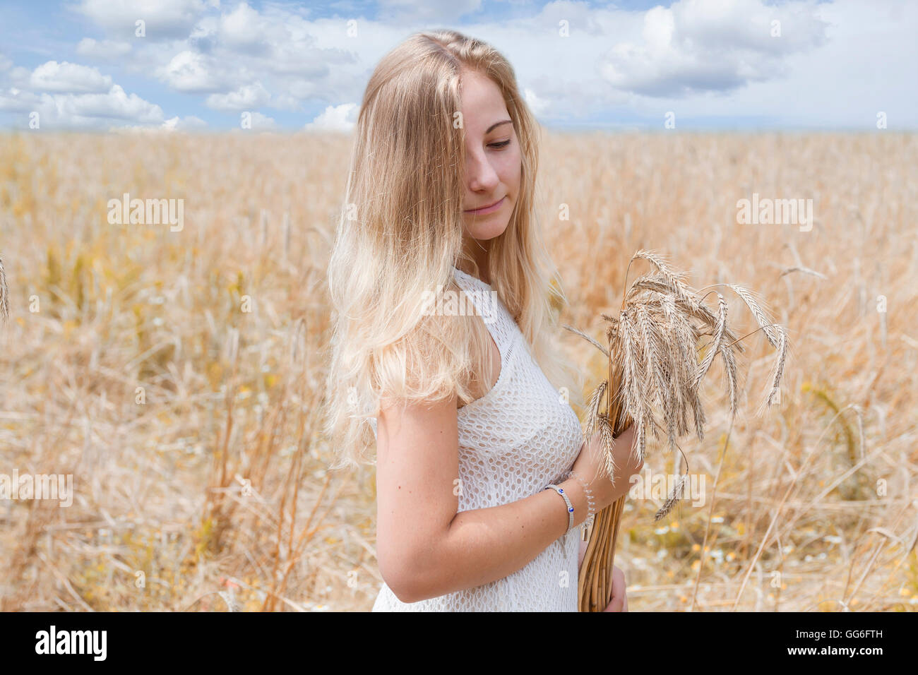 Young woman in golden wheat field Stock Photo - Alamy