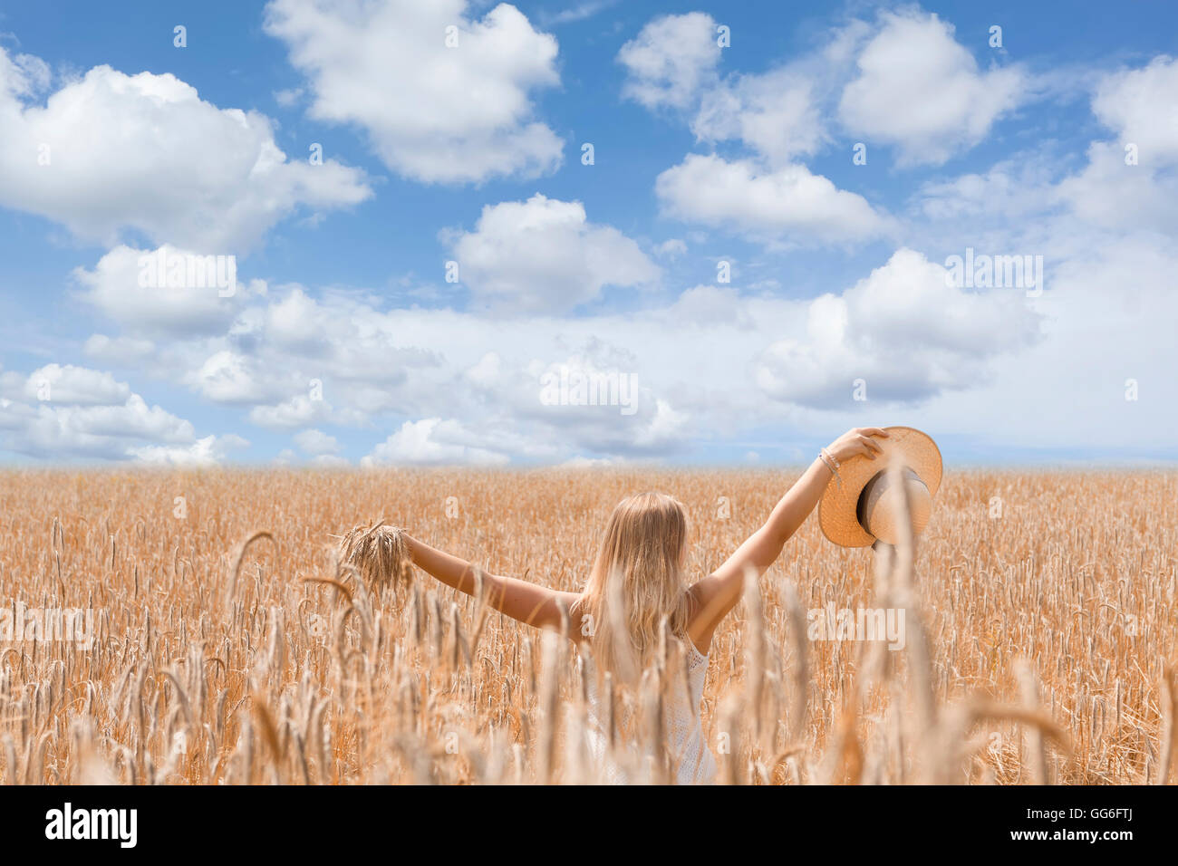 Young woman in golden wheat field Stock Photo - Alamy