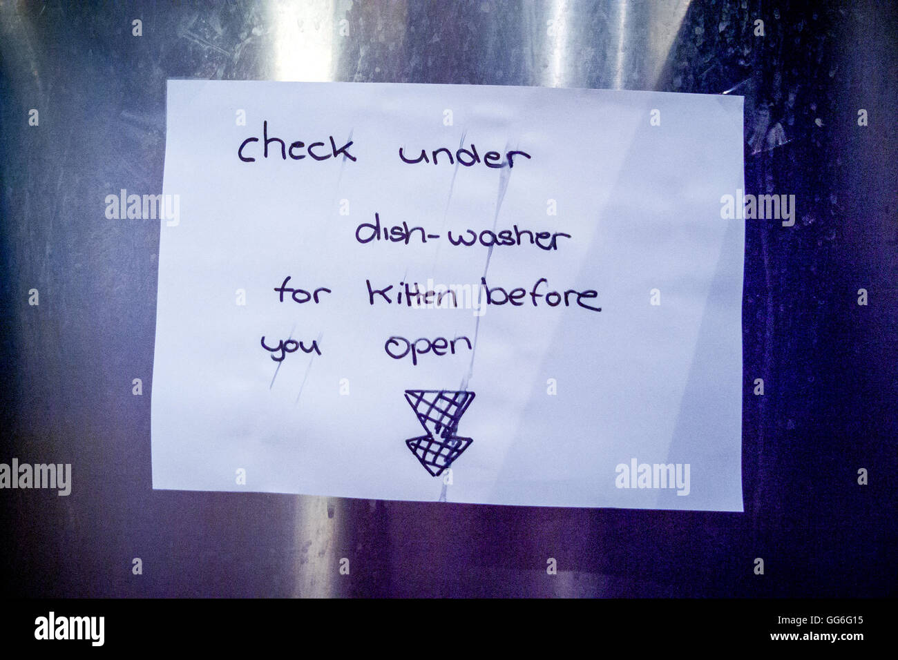 Check under dishwasher for kitten before you open, a humourous notice. Stock Photo