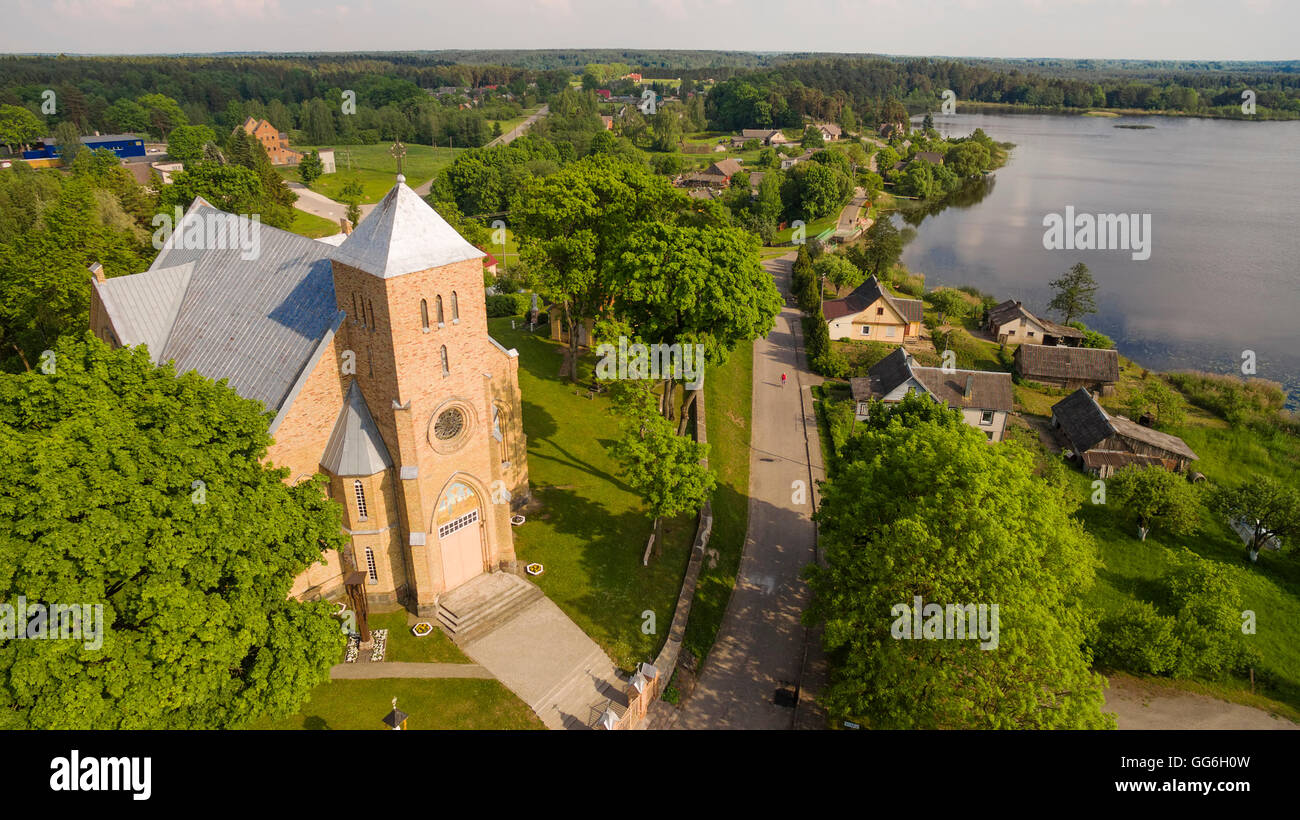 AERIAL. Beautiful summer shot of Vepriai church and lake from the sky Stock Photo