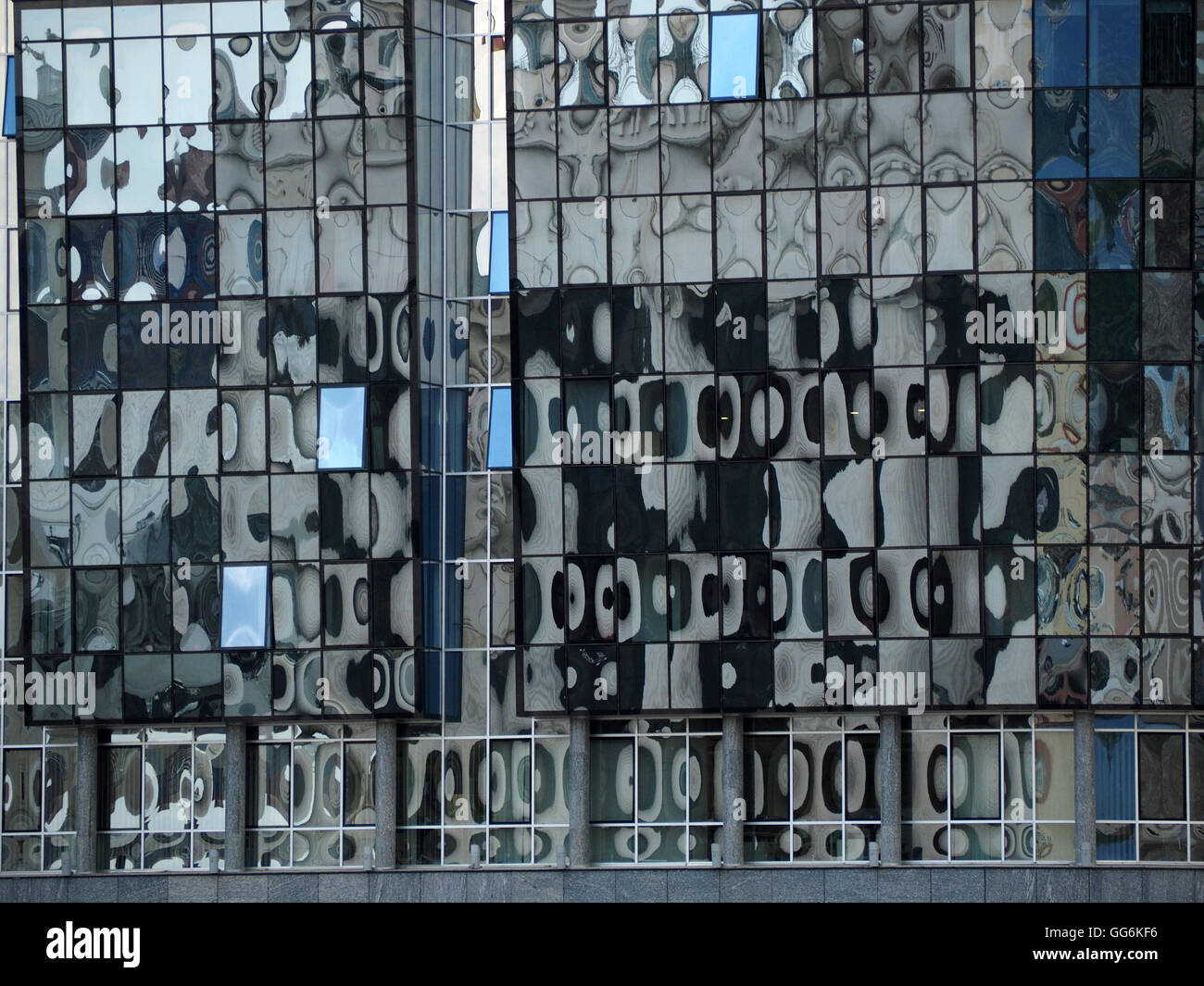 abstract patterns created by reflections in windows of modern blue glass building in Skopje Macedonia Stock Photo