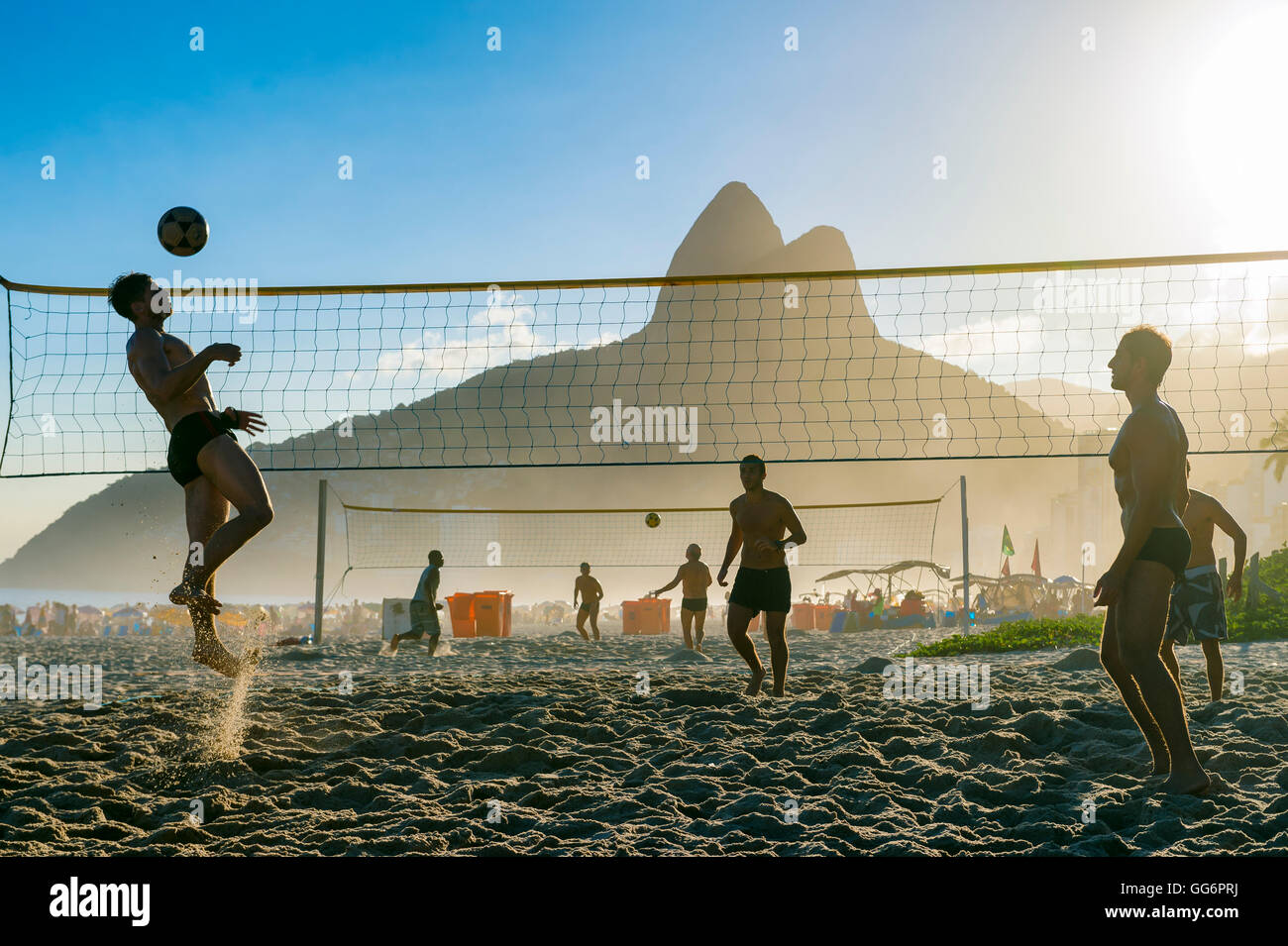 RIO DE JANEIRO - MARCH 27, 2016: Brazilians play futevôlei (footvolley, a sport combining football/soccer and volleyball) . Stock Photo