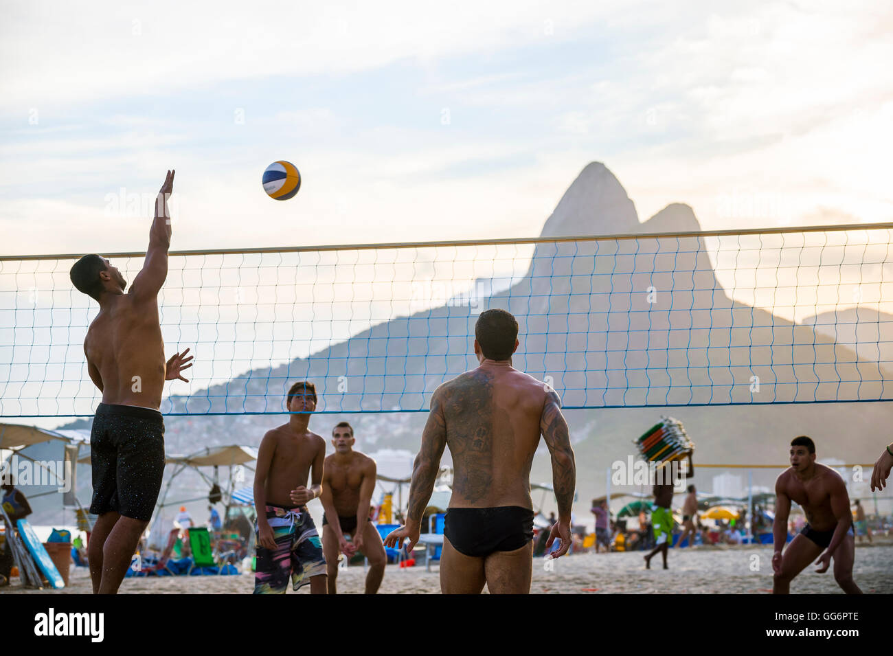 RIO DE JANEIRO - MARCH 20, 2016: Young carioca Brazilians play beach volleyball, a sport Brazil is favored to win in the Games. Stock Photo