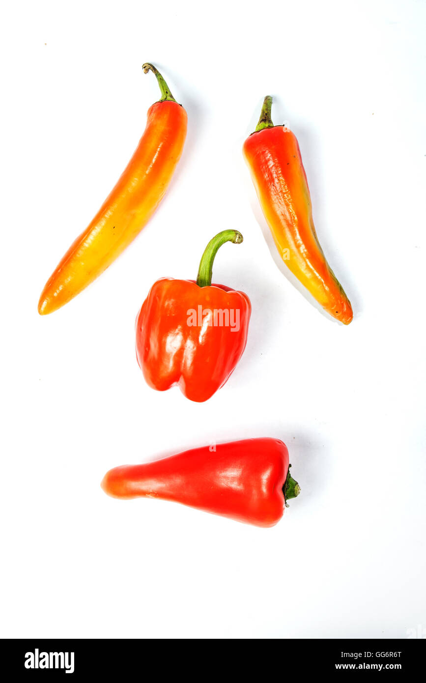 Triangle Form Pepper four red peppers of different shapes on white background Stock Photo ...