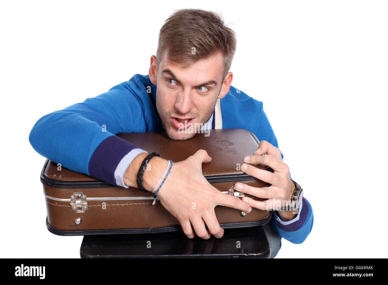 A young man carrying a suitcase Stock Photo Alamy