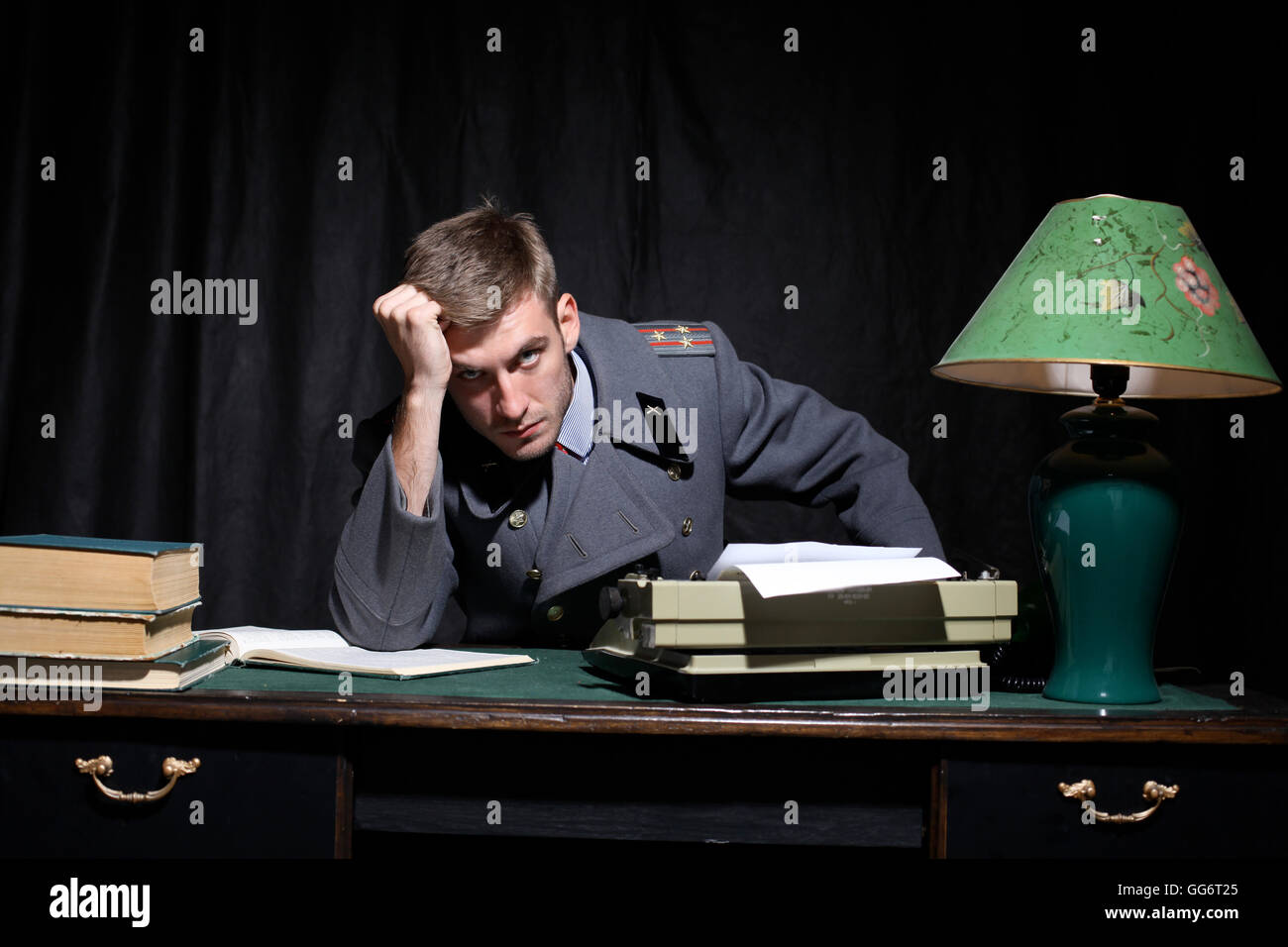 https://c8.alamy.com/comp/GG6T25/russian-military-officer-in-a-dark-cabinet-GG6T25.jpg