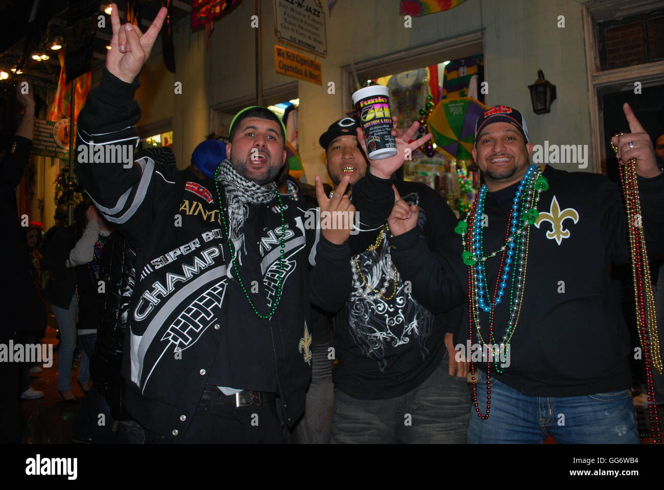 Three football fans celebrating not just Mardi Gras but also the New Orleans Saints historic win in the 2009 Superbowl Stock Photo