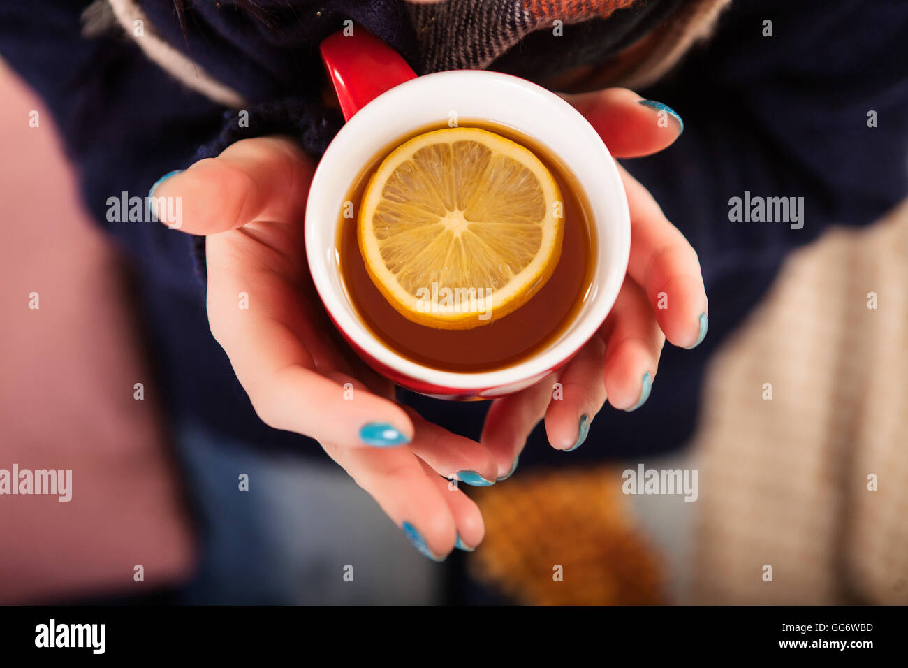 Young woman relaxing in bed with a cup of tea Stock Photo - Alamy