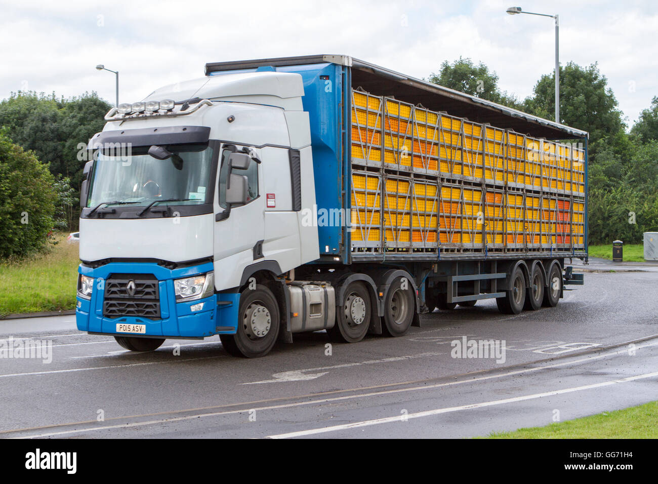 Unmarked lorry transporting caged live chickens, stacked cages and birds in transit. Livestock haulage in Preston, Lancashire, UK Stock Photo