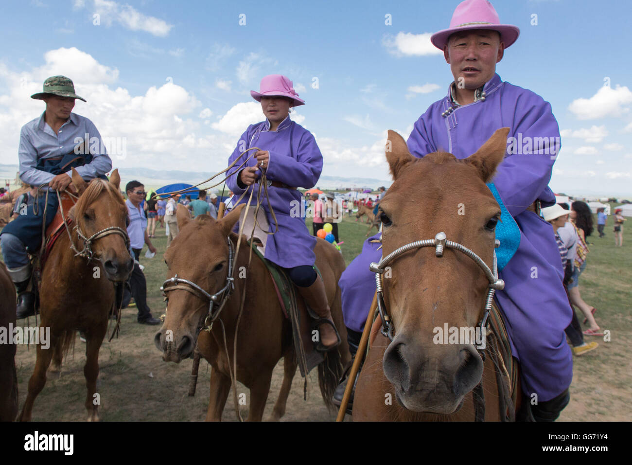 Mongolian horsemen in pink hats Stock Photo