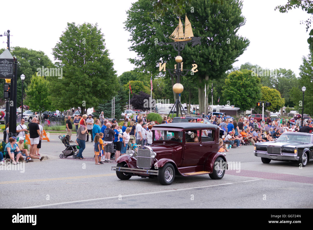 Antique and vintage cars cruise through downtown Montague, Michigan