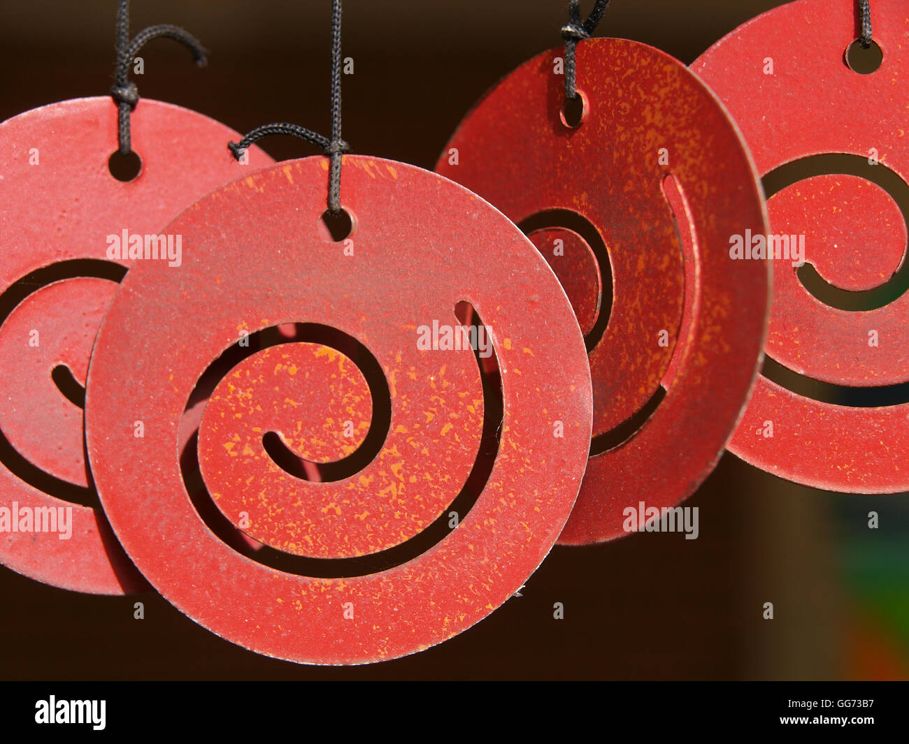 Detail view of a red tin windchime. Stock Photo