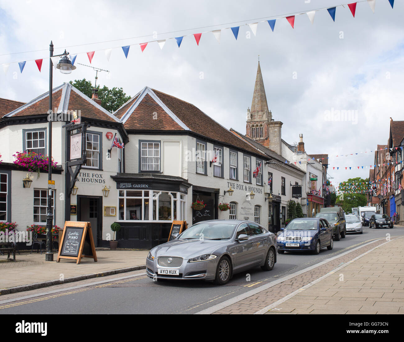 The main street through the New Forest town of Lyndhurst, Hampshire, UK is always a busy one. Stock Photo