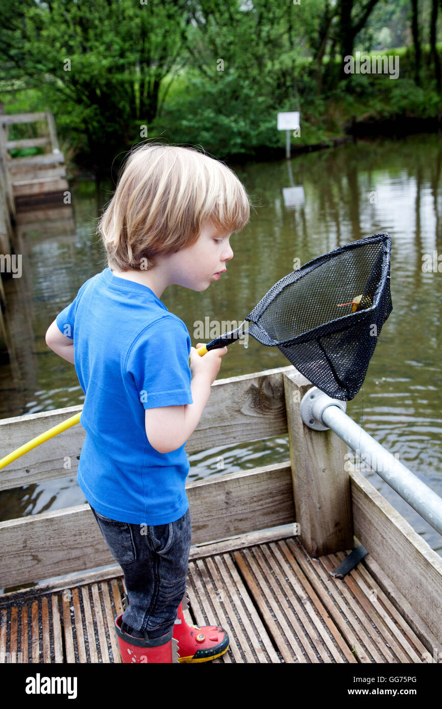 Little boy fishing with a net Stock Photo - Alamy
