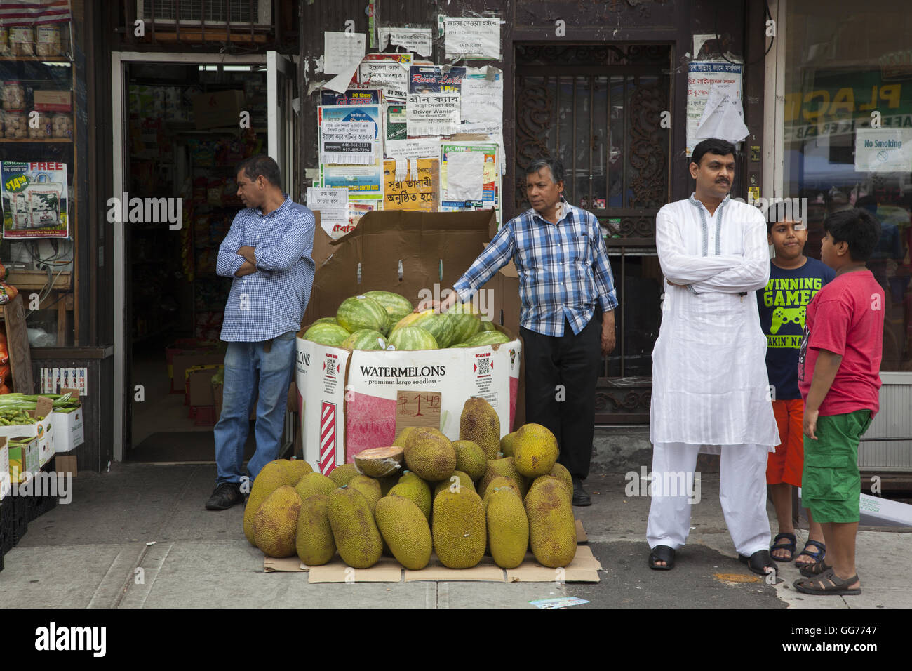 Men stand outside a market in the 'Little Bangladesh' Kensington neighborhood on McDonald Avenue in Brooklyn, New York. Stock Photo