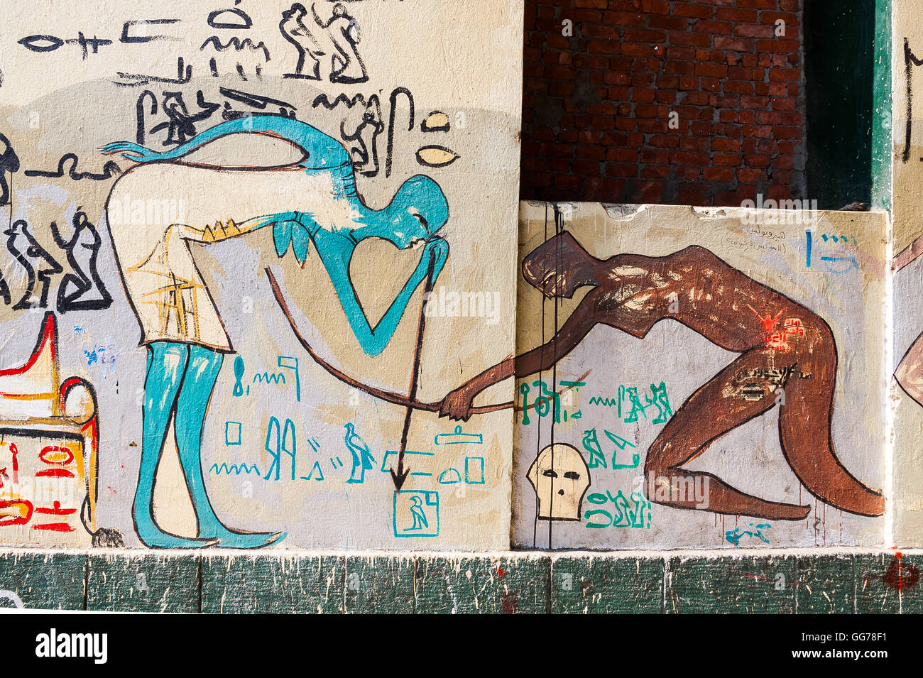 Egypt, Cairo, graffiti of the Egyptian revolution. Inspired by Egyptian antiquities, 2 women bend a bow. Stock Photo