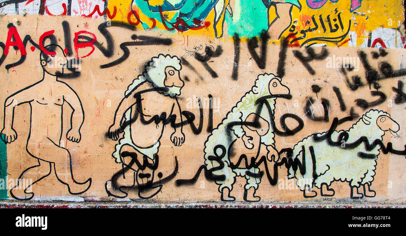Egypt, Cairo, graffiti of the Egyptian revolution : Muslim Brotherhood members are evolving from men to sheeps. Stock Photo