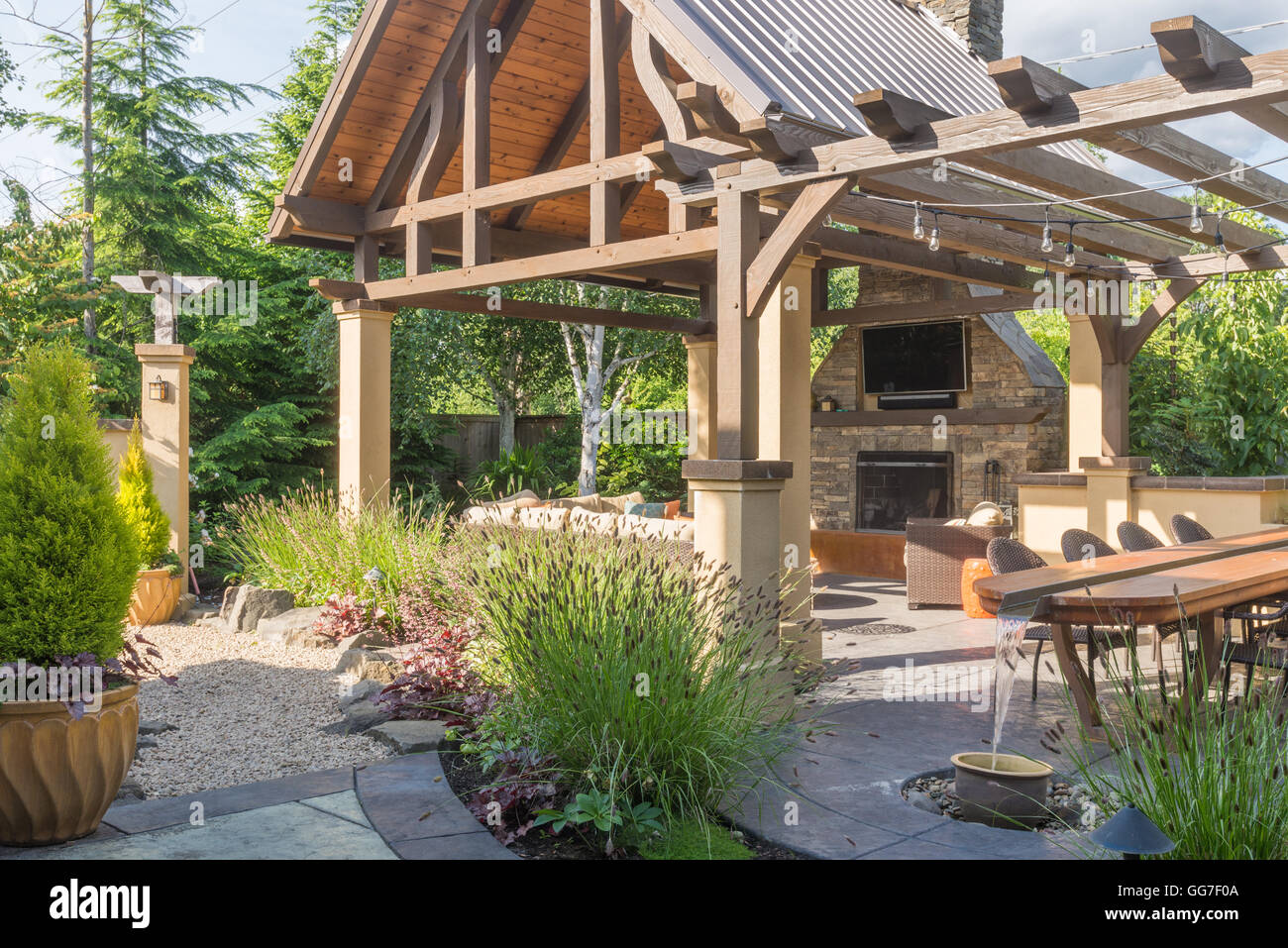 A luxurious backyard patio shelter, complete with fireplace, sofa, and ...
