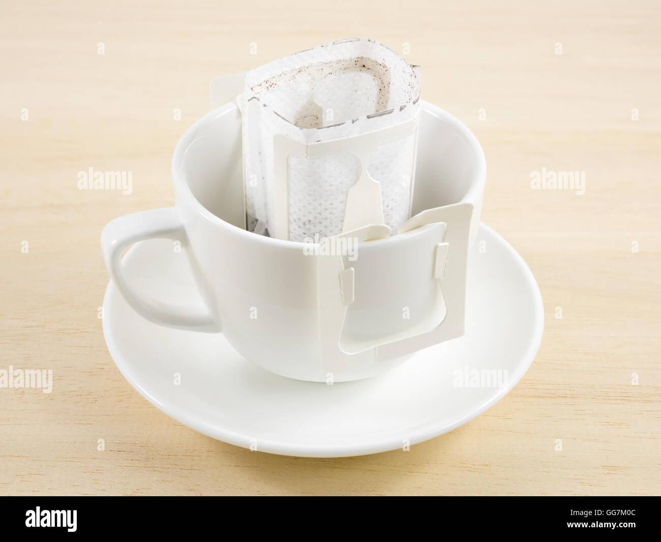 The instant freshly brewed coffee drip bag on white coffee cup Stock