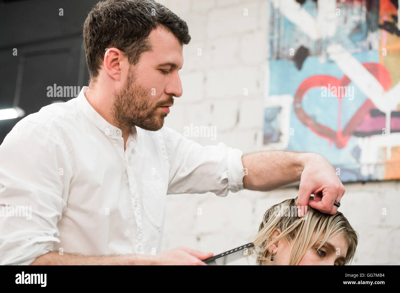 Male hairdresser making haircut for a client in professional hairdressing salon Stock Photo Alamy