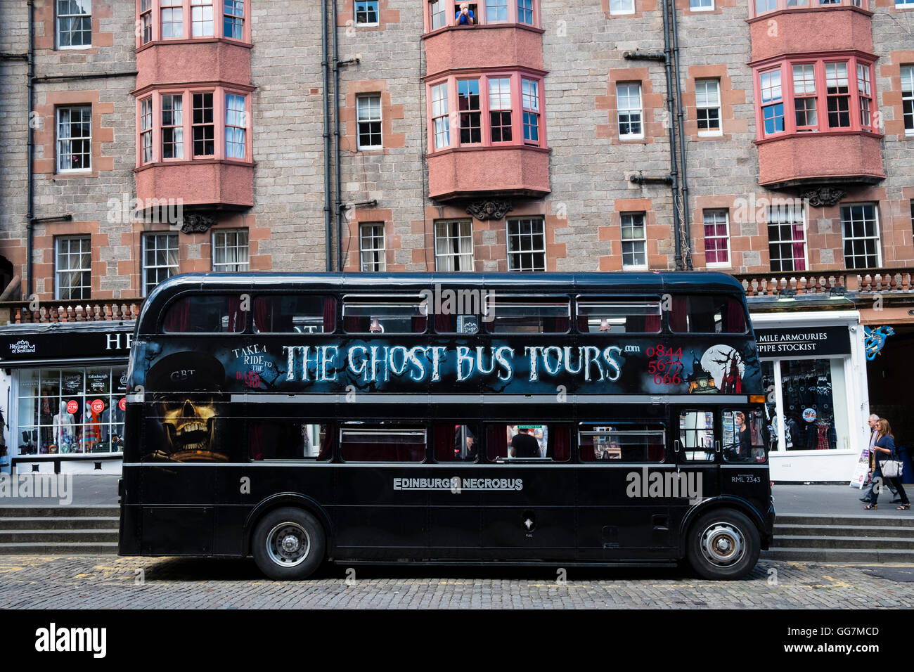 Tourist Ghost Tour double decker bus on the Royal Mile in Edinburgh Scotland, United Kingdom, Stock Photo