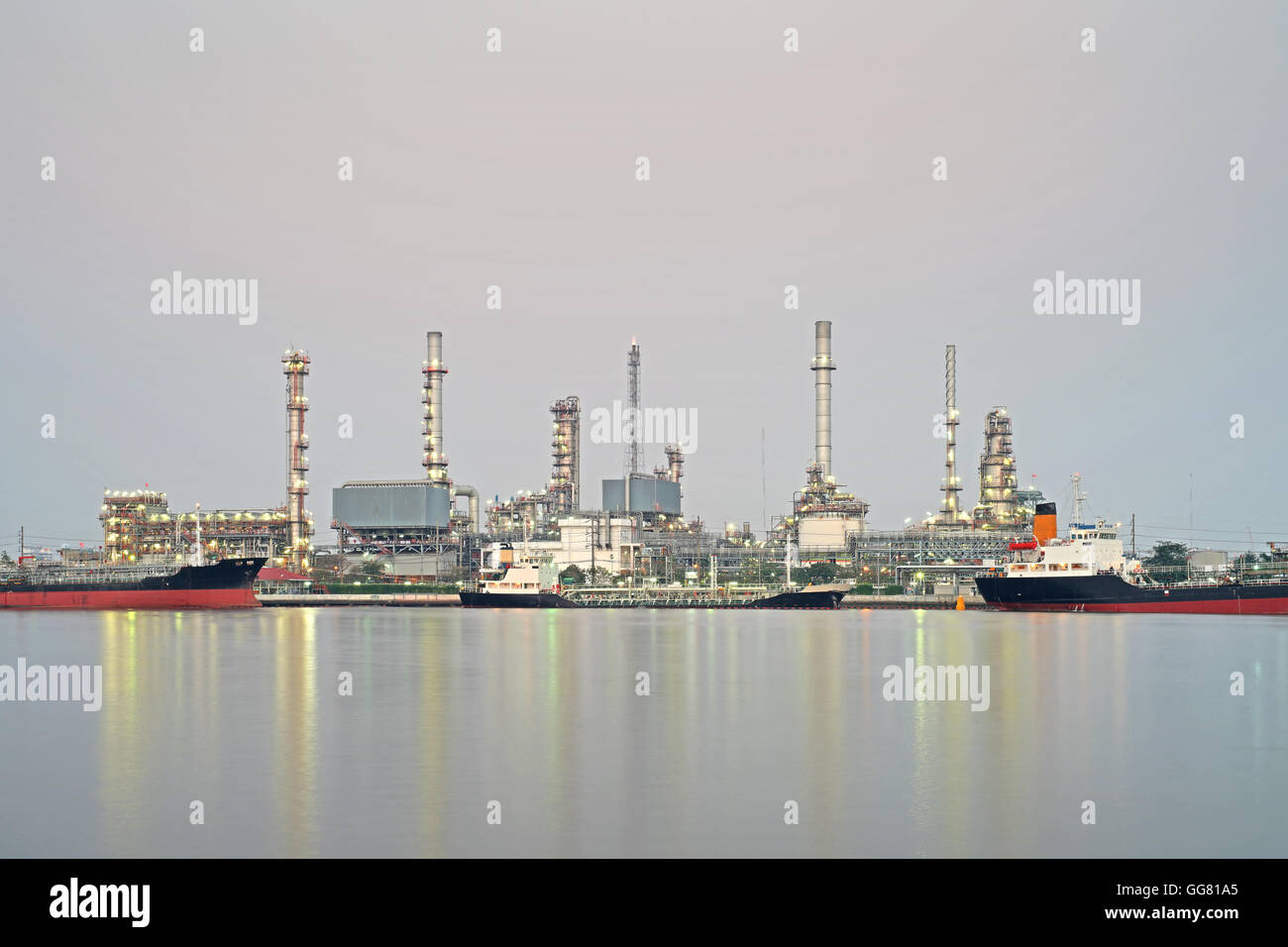 oil refinery along the river with reflection Stock Photo