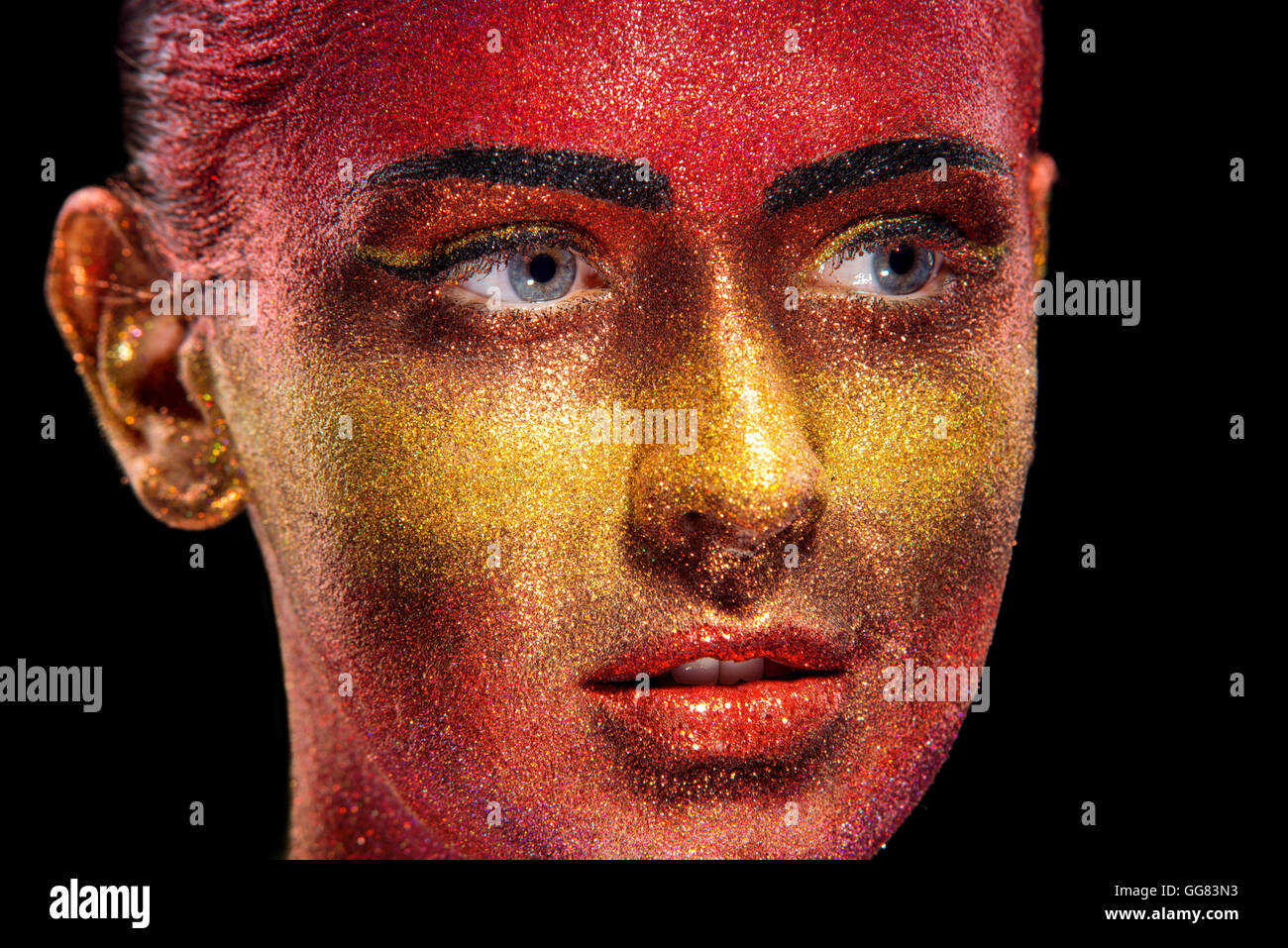 Glitter makeup on a beautiful woman face on a black background. Creative Contemporary Design