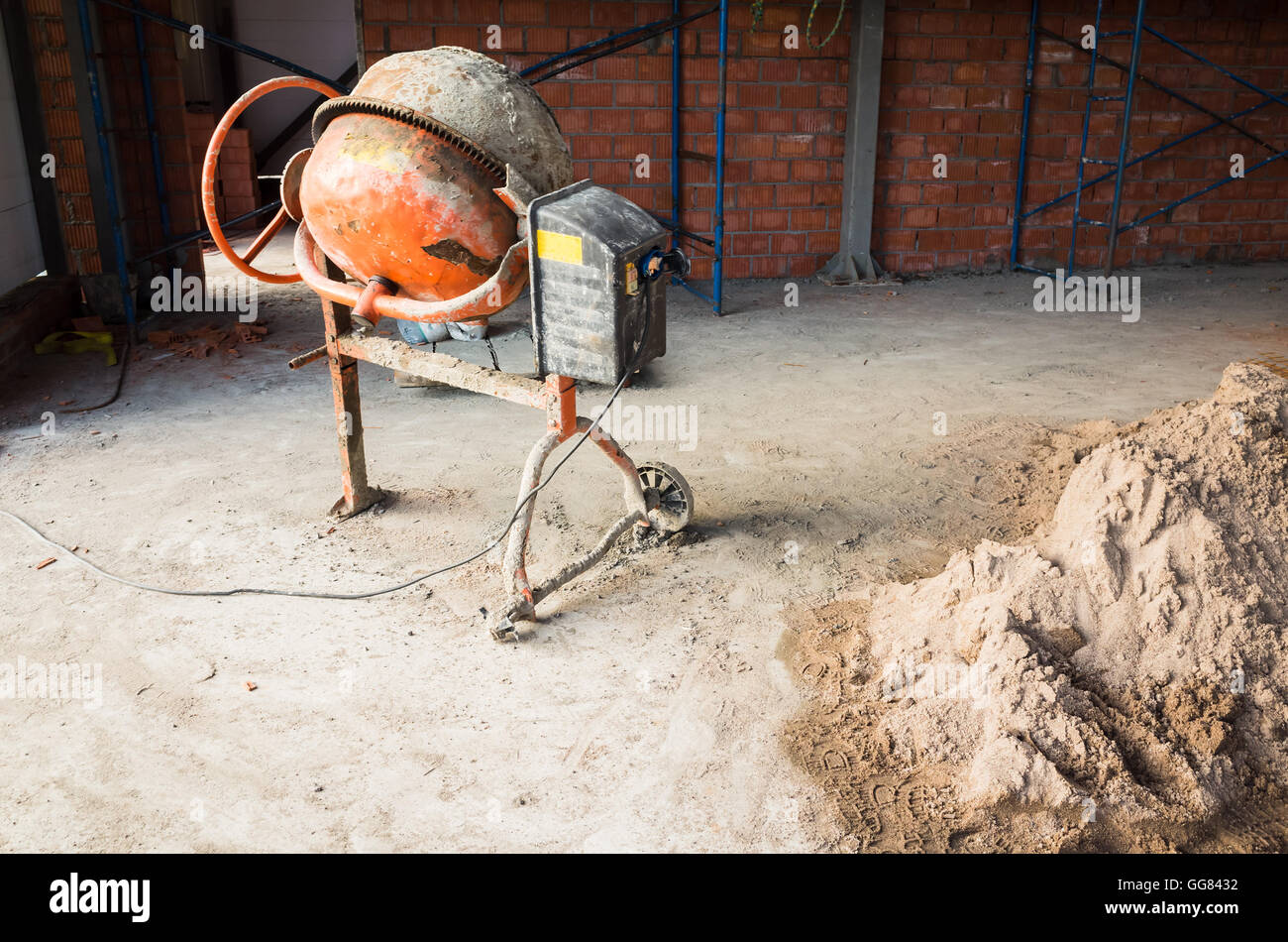 Portable concrete or mortar mixer, industrial building under construction Stock Photo