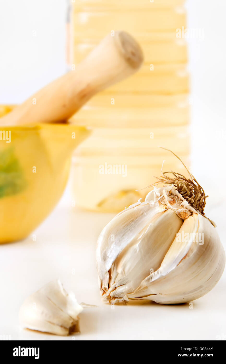 Garlic head with mortar and oil Stock Photo