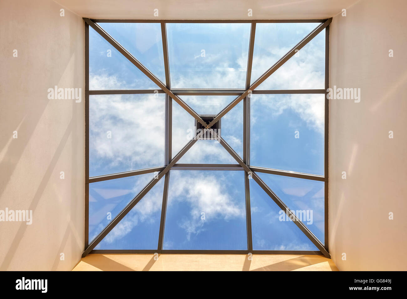 Window in a ceiling with blue sky and clouds, conceptual picture. Stock Photo