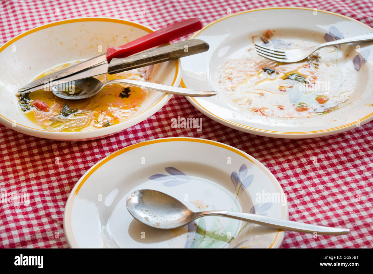 end the meal .some dirty dishes with sauce smeared on some plates Stock Photo