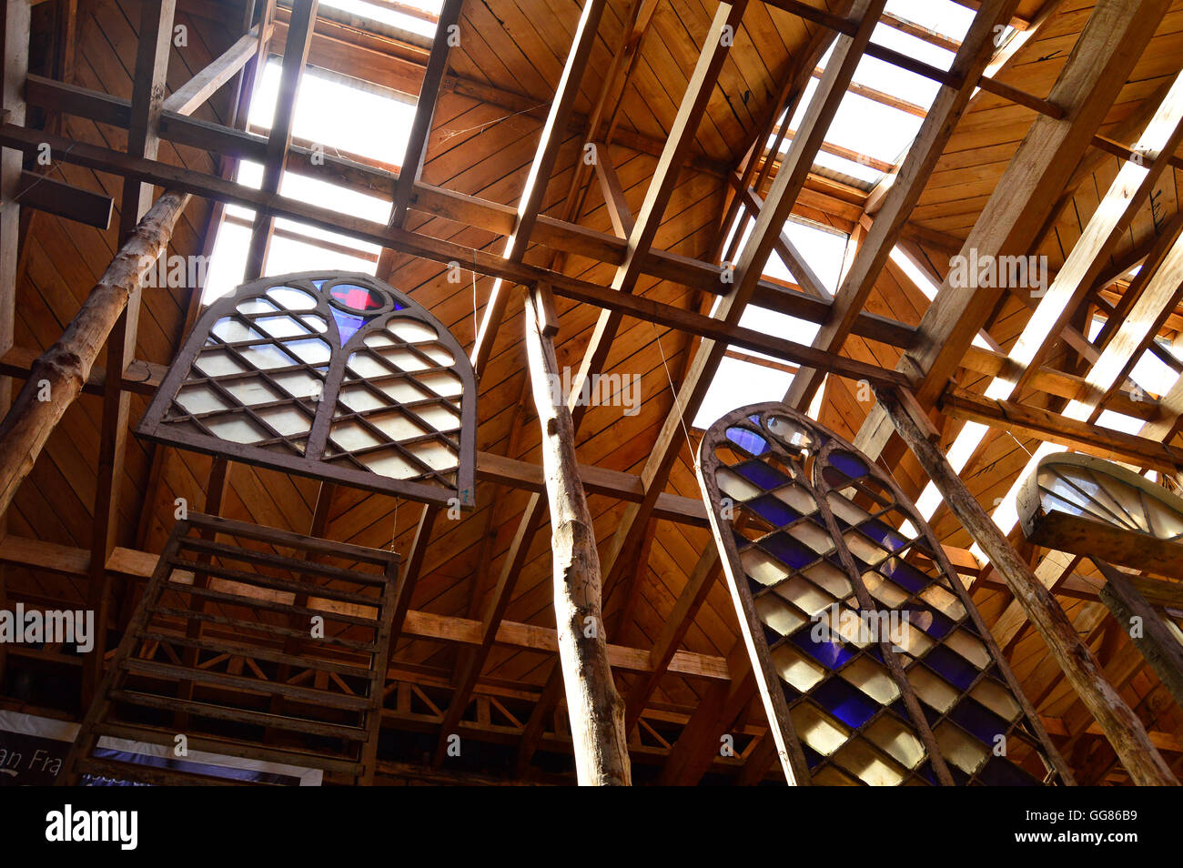 Stained glass windows and high wooden beams at the Museo de las Iglesias de Chiloe, Ancud, Chile Stock Photo