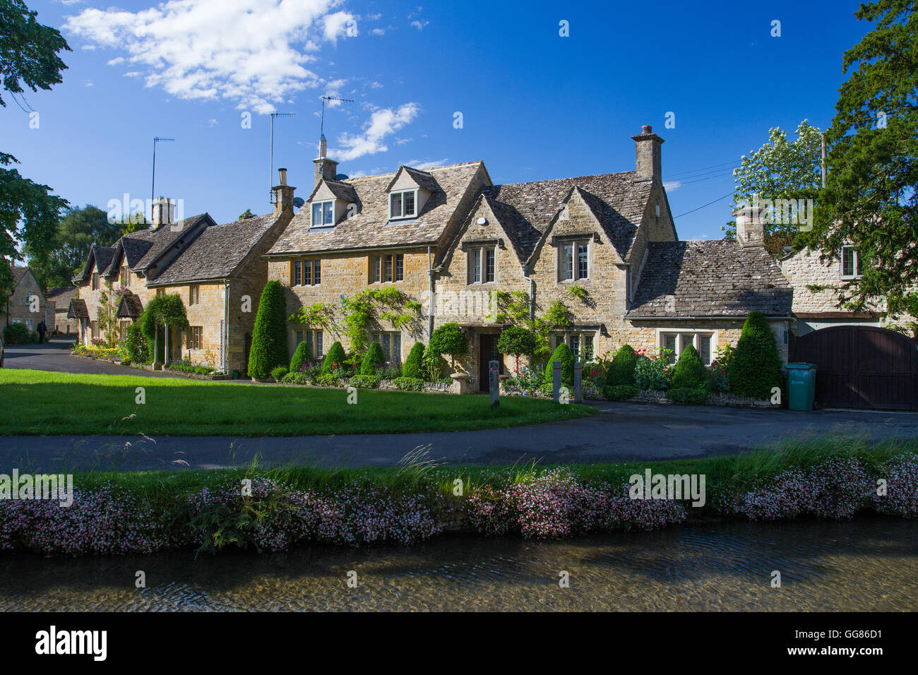 Rows of traditional stone cottages in the village of Lower Slaughter in The popular tourist area of The Cotswolds in the UK. Stock Photo