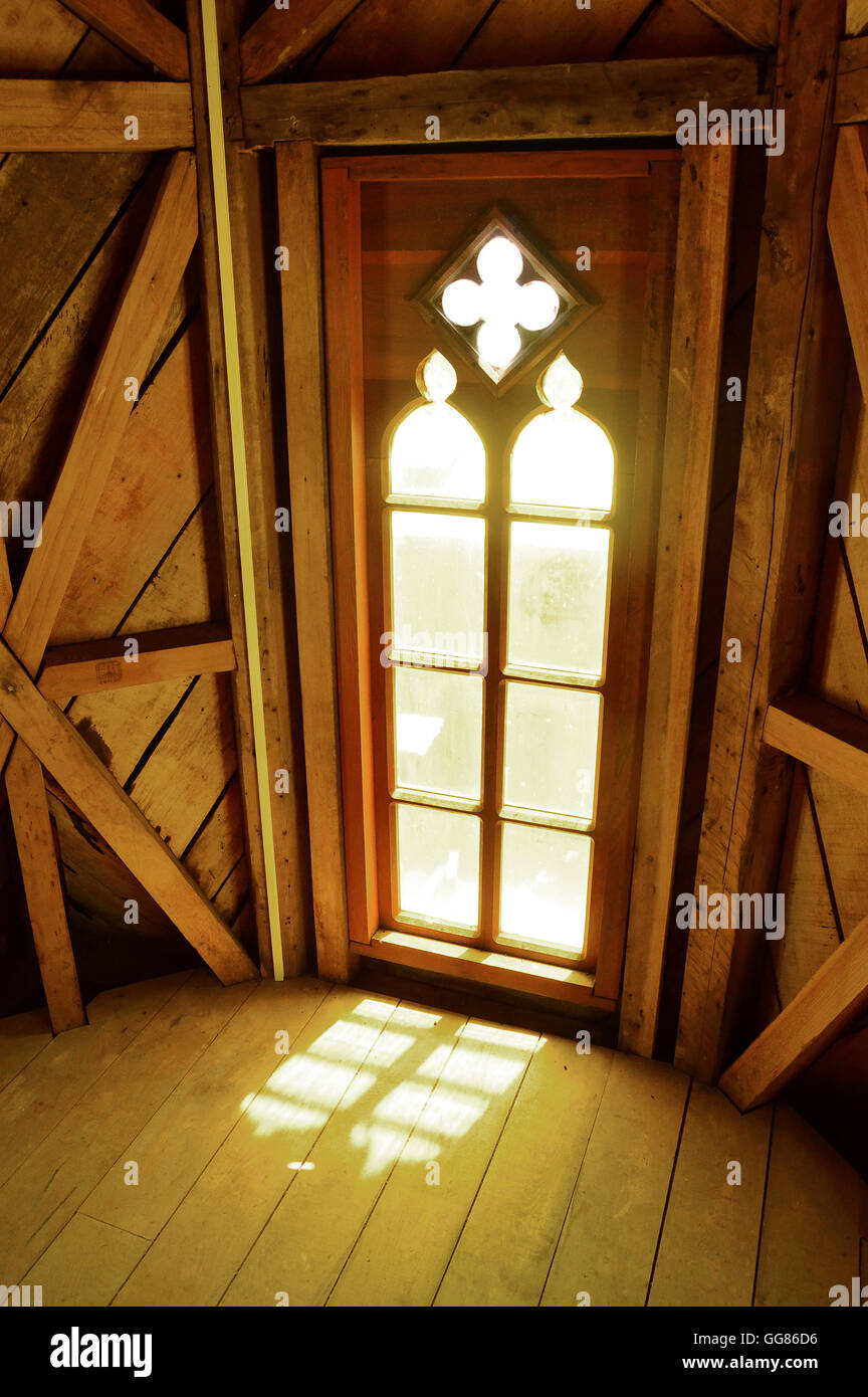 Light pours through a window in the steeple of the Museo de las Iglesias de Chiloe, Ancud, Chile Stock Photo