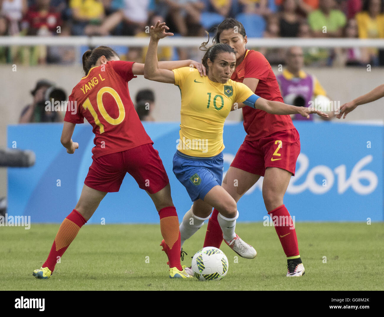 Rio de Janeiro, RJ, Brazil. 3rd Aug, 2016. Rio Olympics 2016 ''“ Li YANG (#10) of team China (left), MARTA (#10) of team Brazil (middle) and Shanshan LIU (#2) of team China in first round soccer action at Olympic Stadium. © Christopher Morris/ZUMA Wire/Alamy Live News Stock Photo