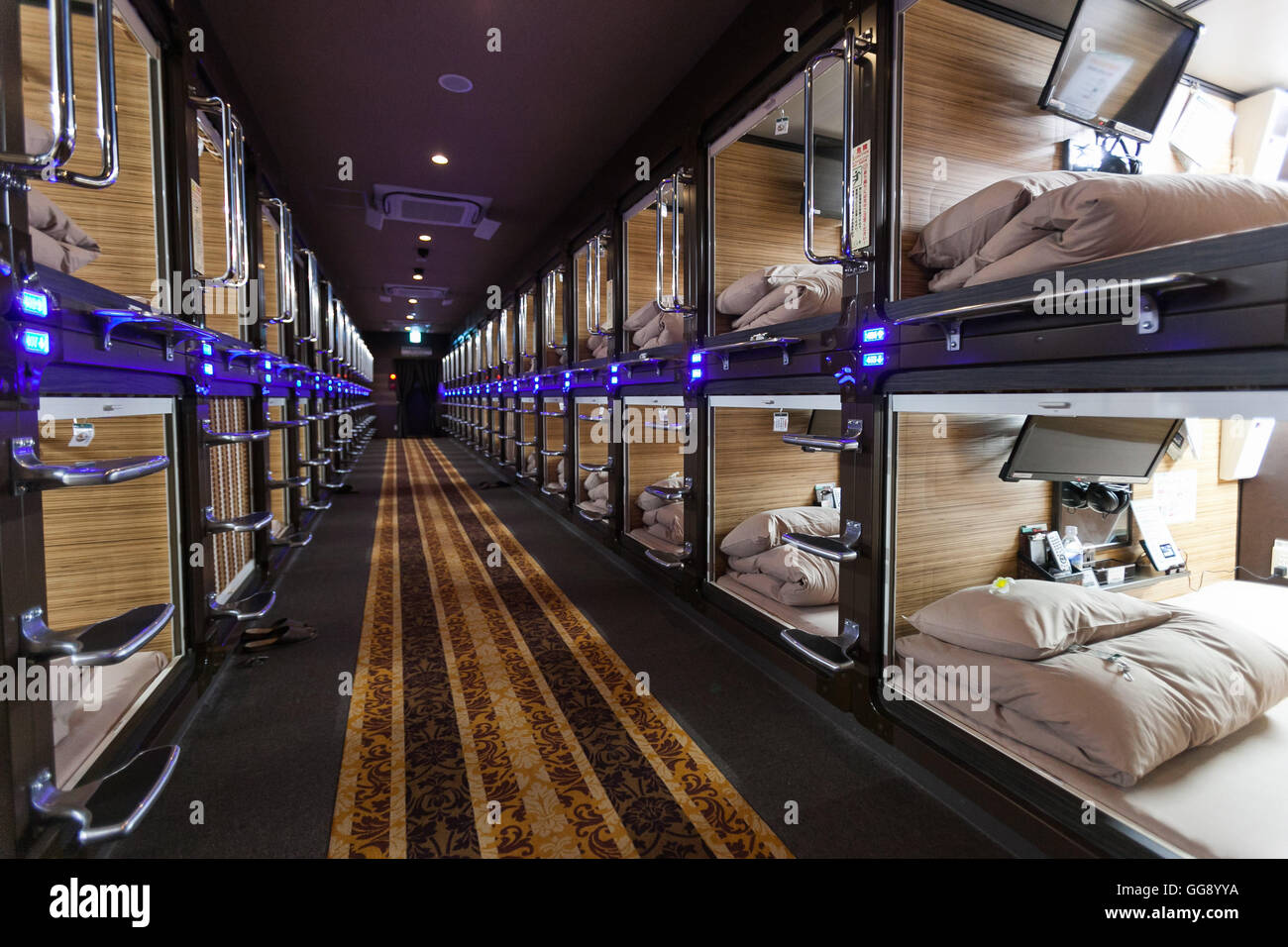 Anshin Oyado luxury capsule hotel located within 3-minutes of the busy Shinjuku station on August 7, 2016, Tokyo, Japan. The new take on the traditional Japanese capsule hotel offers larger capsules, free artificial hot springs & mist sauna, internet cafe and Wi-Fi. This hotel is male only and rates start at 5480 yen (54USD). Each of the hotel's 256 capsules is equipped with fire alarm, air conditioner, tablet computer and flat-screen TV. Public areas such as the hot springs bath, laundromat, clothing shop and snack and drinks vending machines are open 24 hours. The hotel's website is in Chine Stock Photo