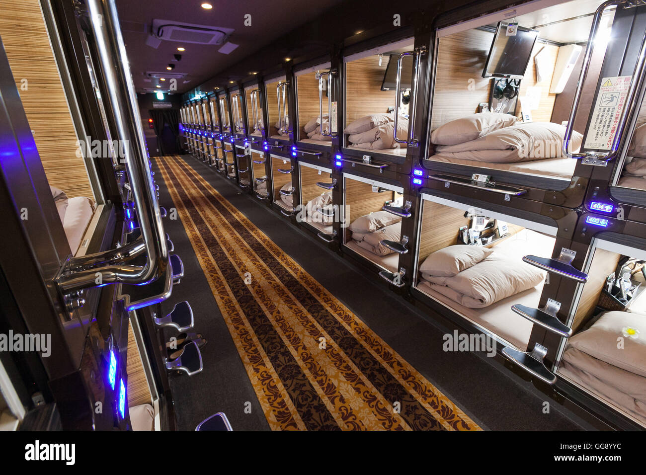 Anshin Oyado luxury capsule hotel located within 3-minutes of the busy Shinjuku station on August 7, 2016, Tokyo, Japan. The new take on the traditional Japanese capsule hotel offers larger capsules, free artificial hot springs & mist sauna, internet cafe and Wi-Fi. This hotel is male only and rates start at 5480 yen (54USD). Each of the hotel's 256 capsules is equipped with fire alarm, air conditioner, tablet computer and flat-screen TV. Public areas such as the hot springs bath, laundromat, clothing shop and snack and drinks vending machines are open 24 hours. The hotel's website is in Chine Stock Photo