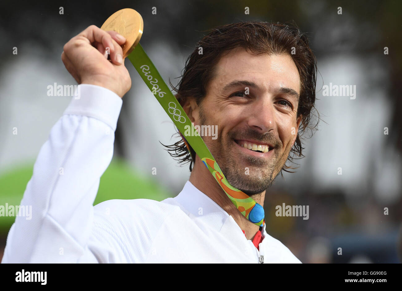 Rio de Janeiro, Brazil. 10th Aug, 2016. Fabian Cancellara of Switzerland celebrates on the podium with the gold medal after winning the men's Individual Time Trial of the Rio 2016 Olympic Games Road Cycling events at Pontal in Rio de Janeiro, Brazil, 10 August 2016.Photo: Sebastian Kahnert/dpa/Alamy Live News Stock Photo