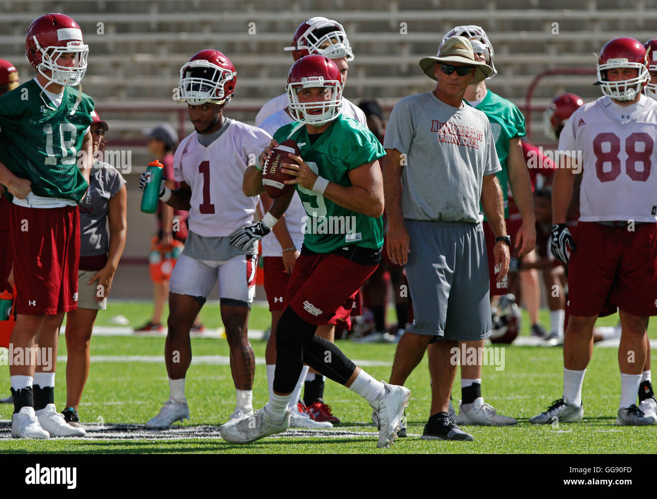 Las Cruces, NM, USA. 8th Aug, 2016. New Mexico State quarterback Tyler Matthews searches for a receiver under the look of head coach Doug Martin and fellow players during practice at the Aggie Memorial Stadium in Las Cruces, Monday, Aug. 8, 2016. © Andres Leighton/Albuquerque Journal/ZUMA Wire/Alamy Live News Stock Photo