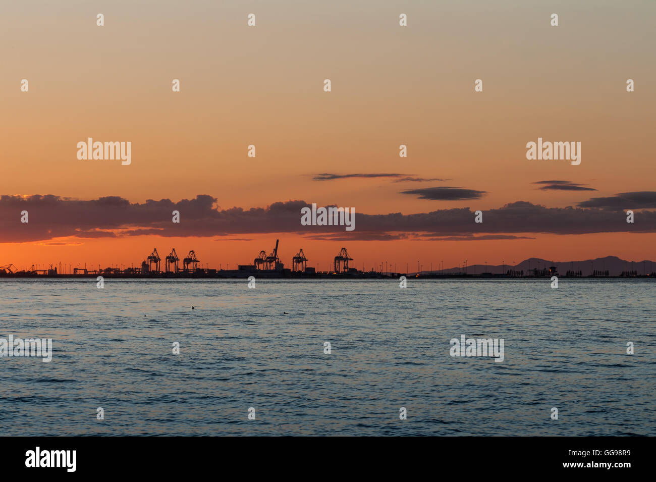 Sun dawn over the cranes from Point Roberts, Washington State, USA Stock Photo