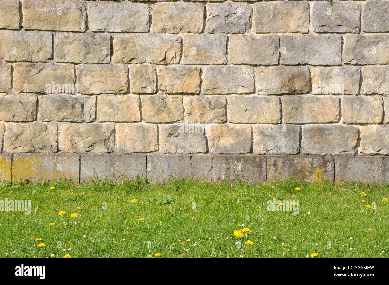 Stone wall with green grass Stock Photo - Alamy