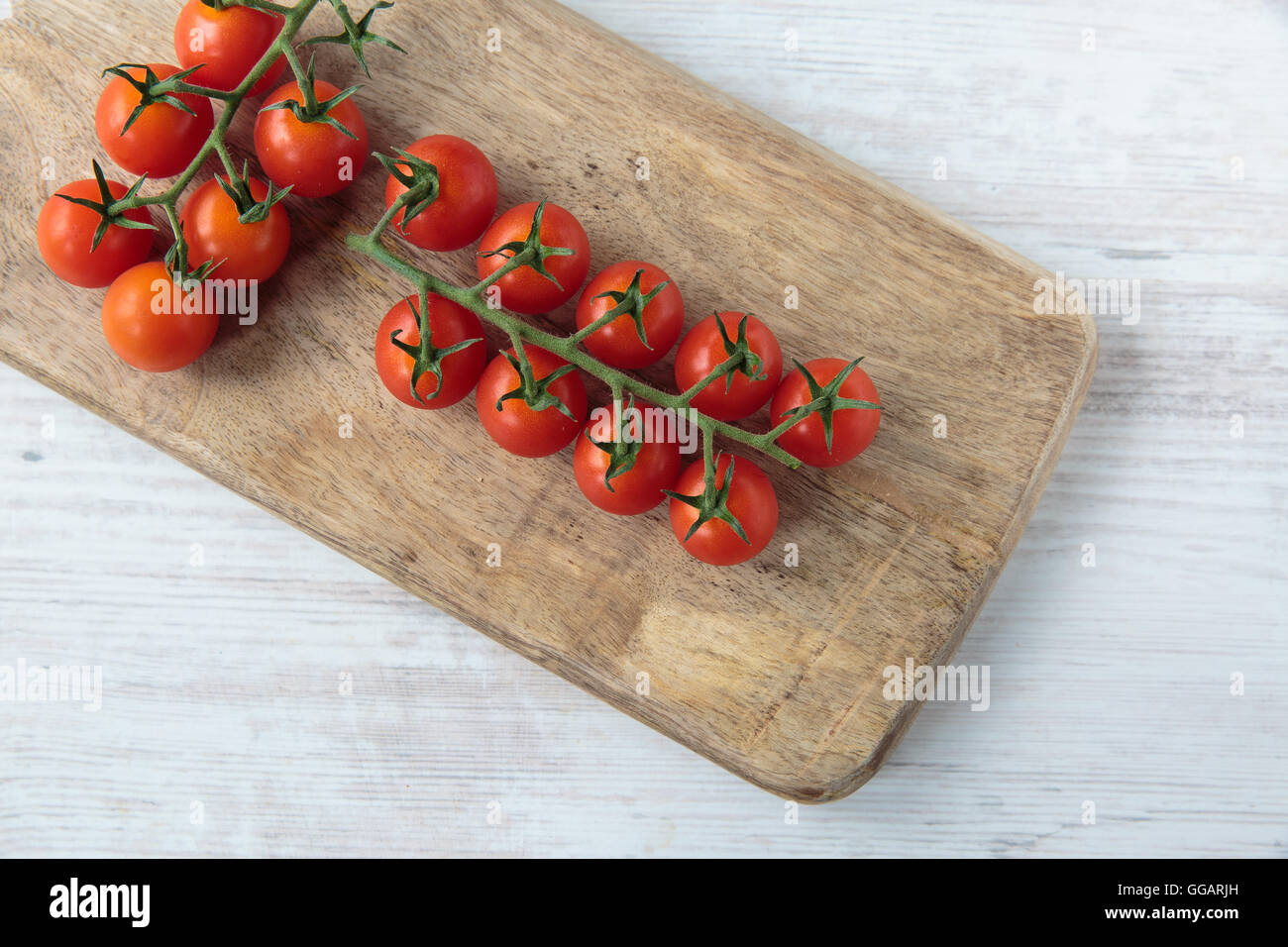 Fresh raw cherry tomatoes on a chopping board Stock Photo - Alamy