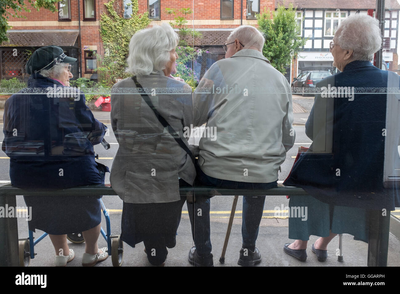 Old people at a bus stop in the UK Stock Photo
