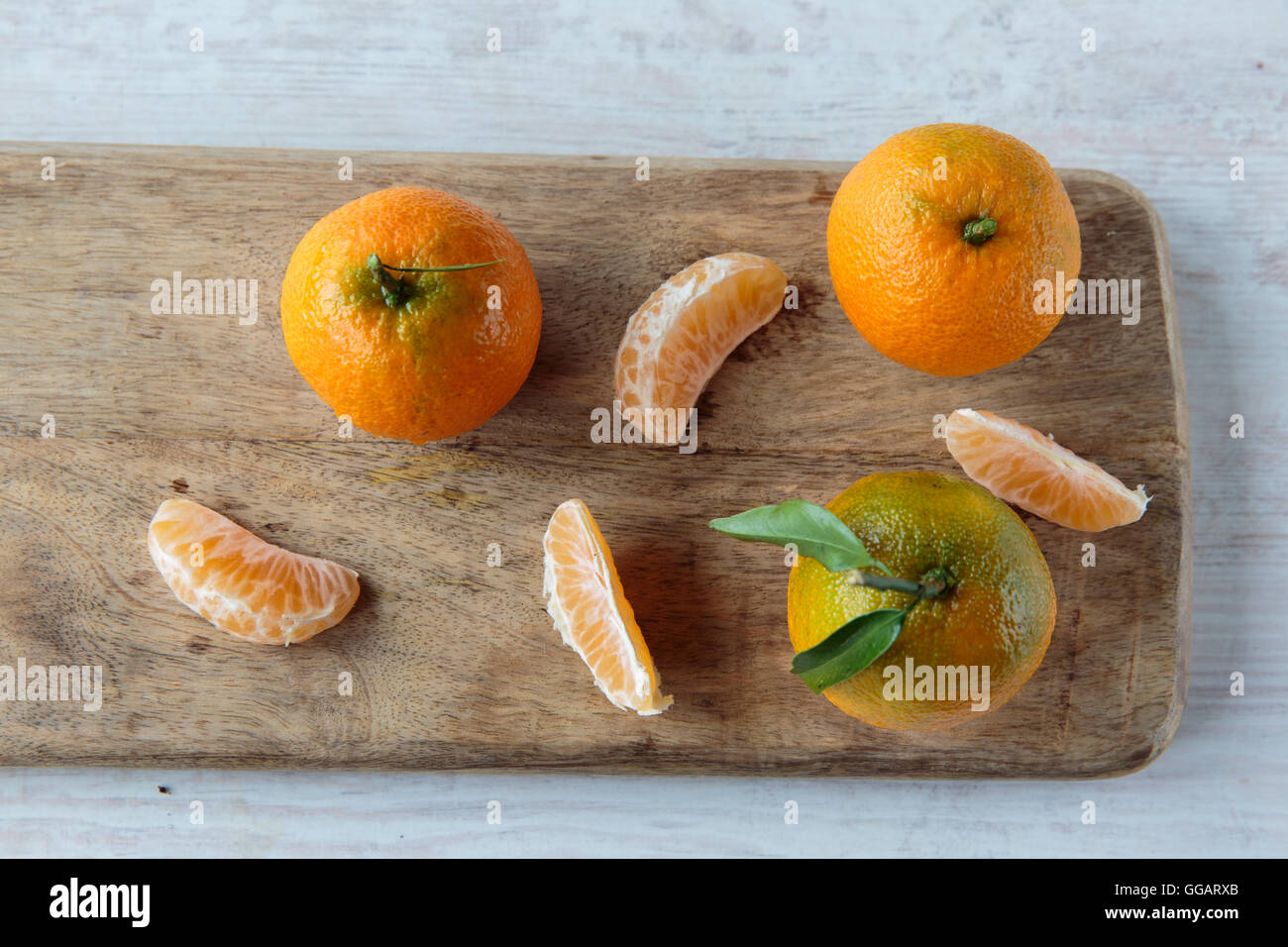 Fesh raw clementine fruits on a chopping board Stock Photo