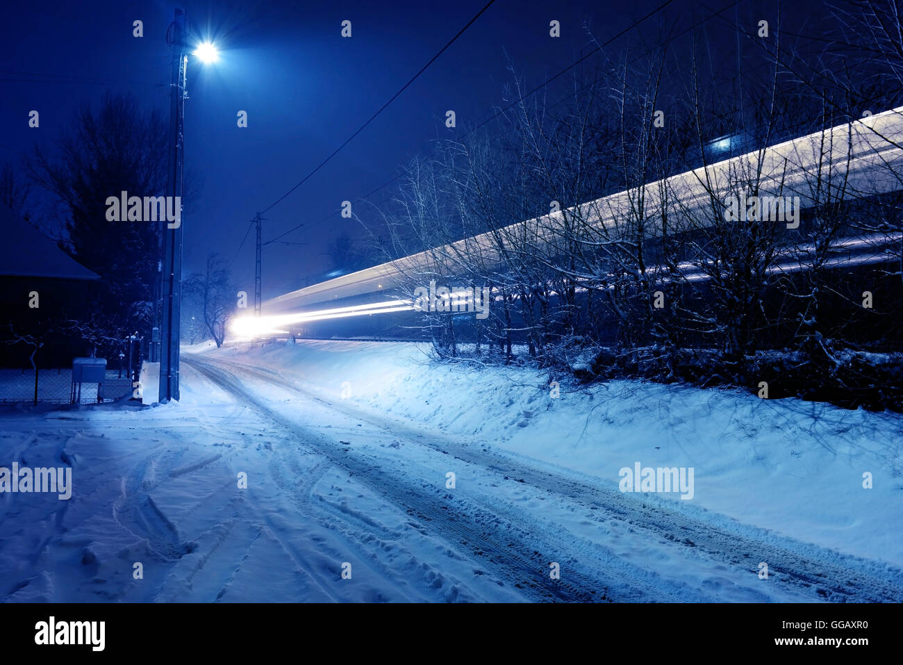 Winter night with a train light strip Stock Photo - Alamy