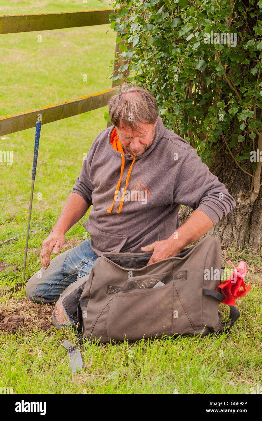 Mark Clark the mole catcher setting mole traps in Suffolk , England , Britain , Uk Stock Photo
