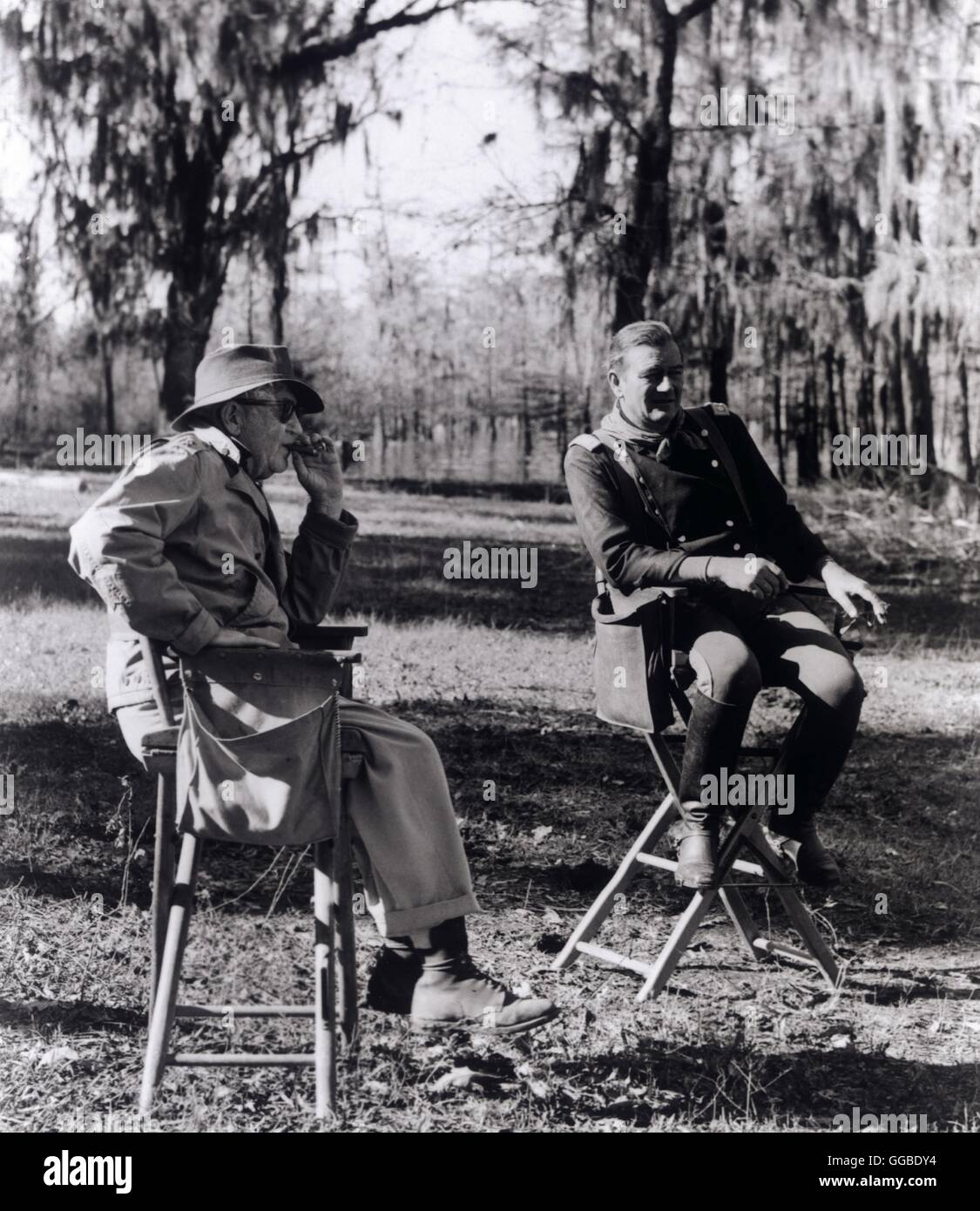 Director JOHN FORD and JOHN WAYNE on film location: 'The Horse Soldiers' (1959) Stock Photo